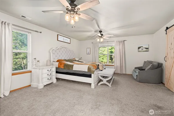 a bedroom with furniture and windows