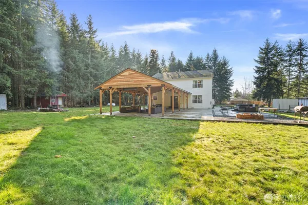 a view of a house with swimming pool and a yard