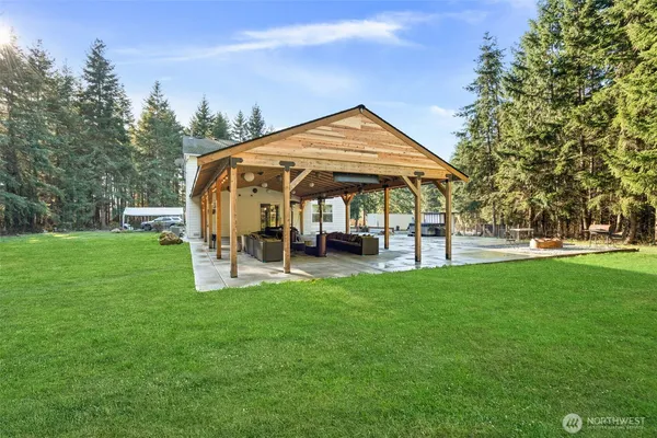 a view of a house with backyard porch and sitting area