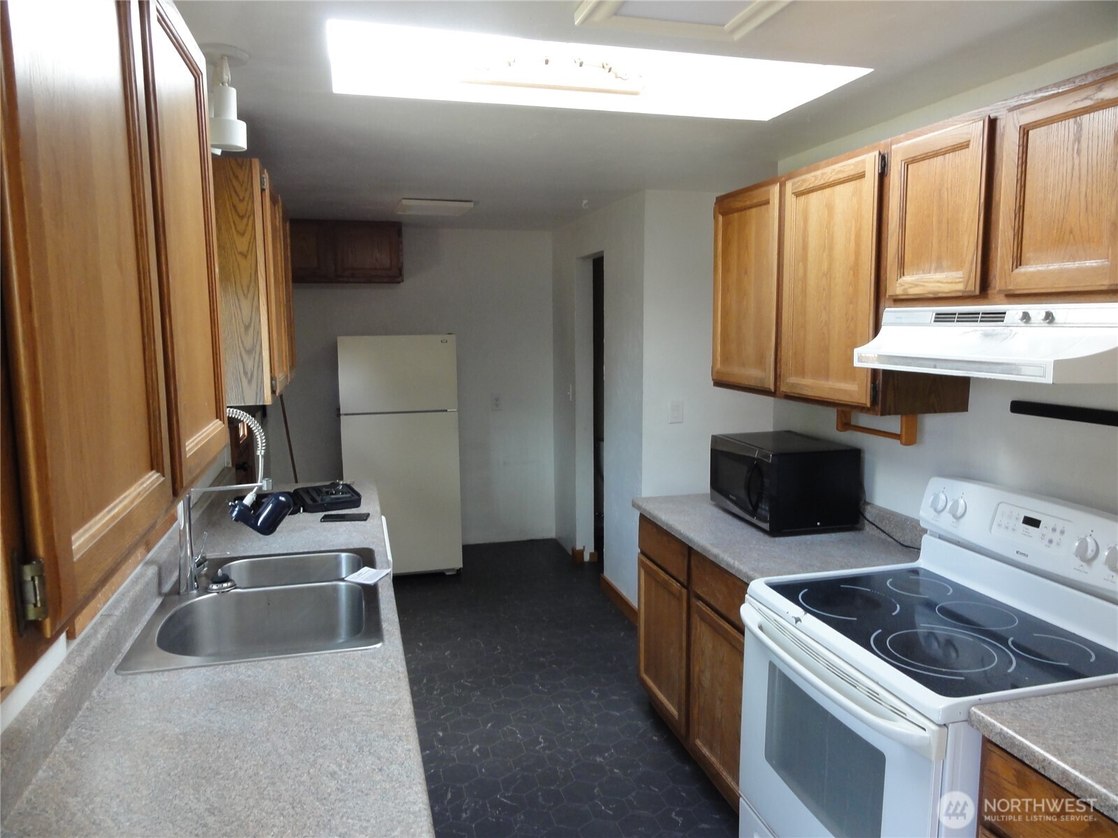 28821 18th Avenue South Federal Way, WA 98003 - Photo 4 of 14 a kitchen with stainless steel appliances a stove a sink and a microwave