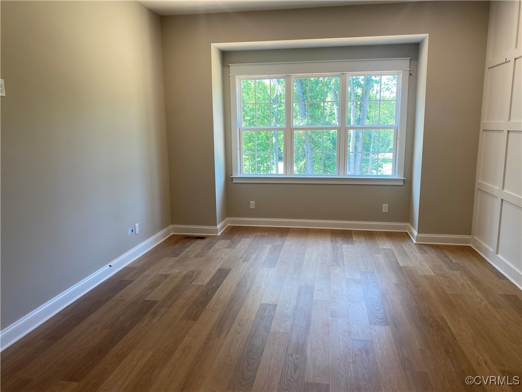 2263 Osborne Rdg Road Rockville, VA 23146 - Photo 17 of 22 an empty room with wooden floor and windows