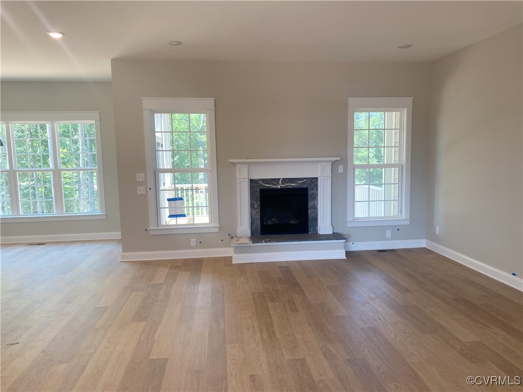 2263 Osborne Rdg Road Rockville, VA 23146 - Photo 5 of 22 an empty room with wooden floor fireplace and windows
