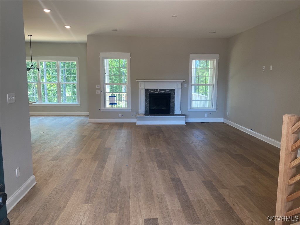 2263 Osborne Rdg Road Rockville, VA 23146 - Photo 6 of 22 an empty room with wooden floor a fireplace and windows