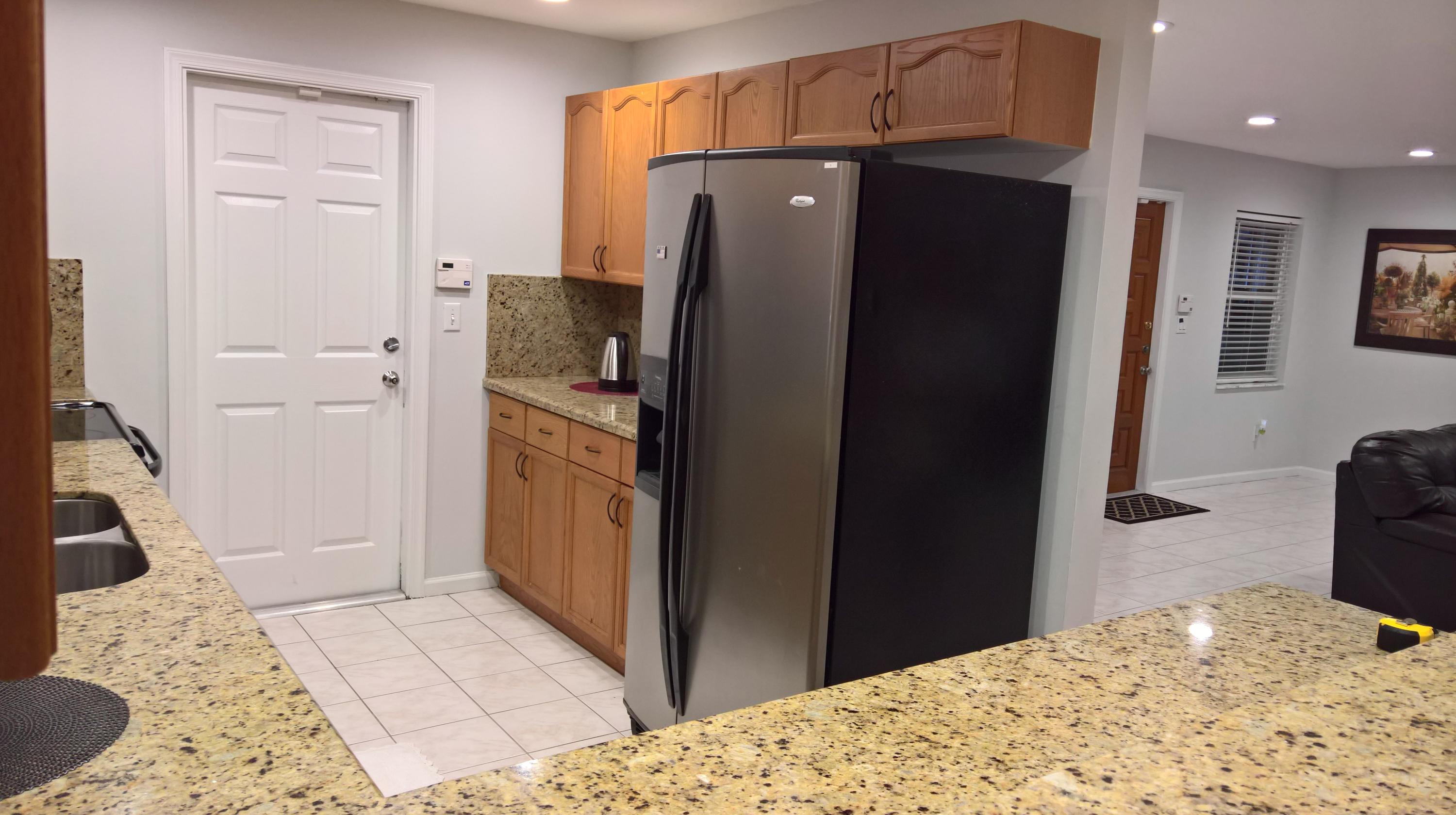 15035 Jackson Road Delray Beach, FL 33484 - Photo 5 of 17 a kitchen with stainless steel appliances kitchen island granite countertop a refrigerator and a sink