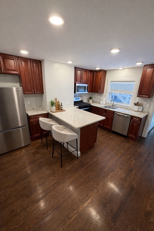 a room with a table chairs and a kitchen view