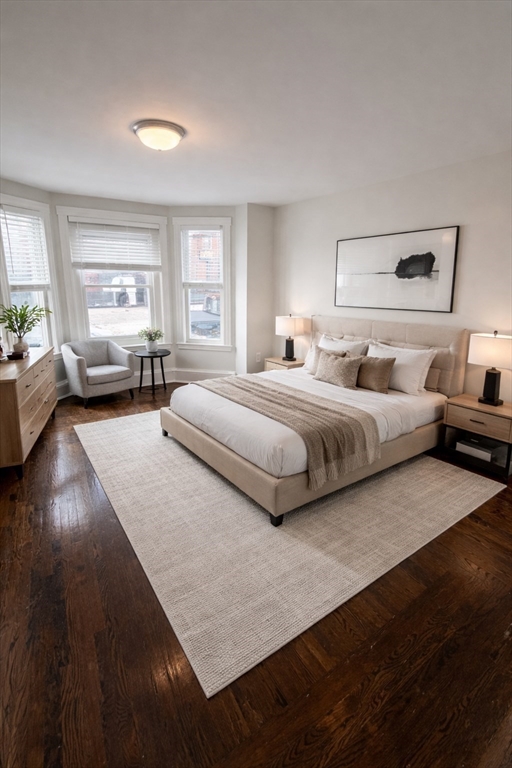 83 Chelsea Street, Unit 1 Boston, MA 02128 - Photo 3 of 7 a spacious bedroom with a bed and windows