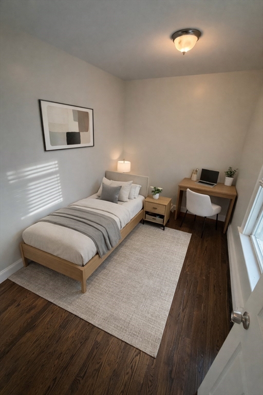 83 Chelsea Street, Unit 1 Boston, MA 02128 - Photo 4 of 7 a bedroom with a bed and a chandelier