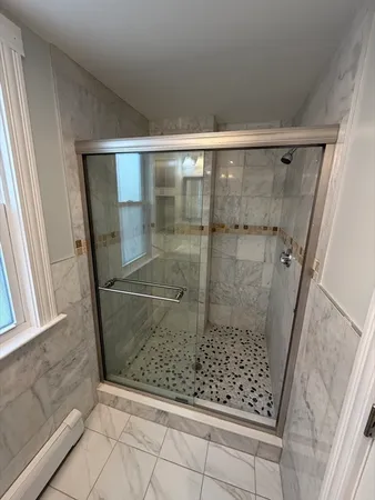 a bathroom with a glass shower door