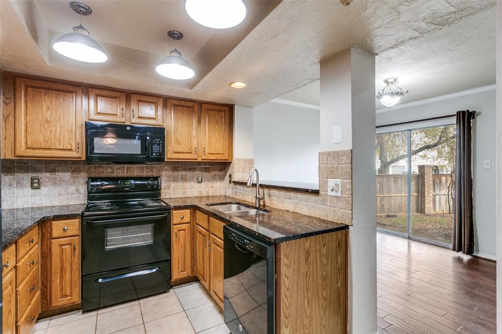 9416 Penny Lane Irving, TX 75063 - Photo 11 of 21 a kitchen with granite countertop a stove and a sink