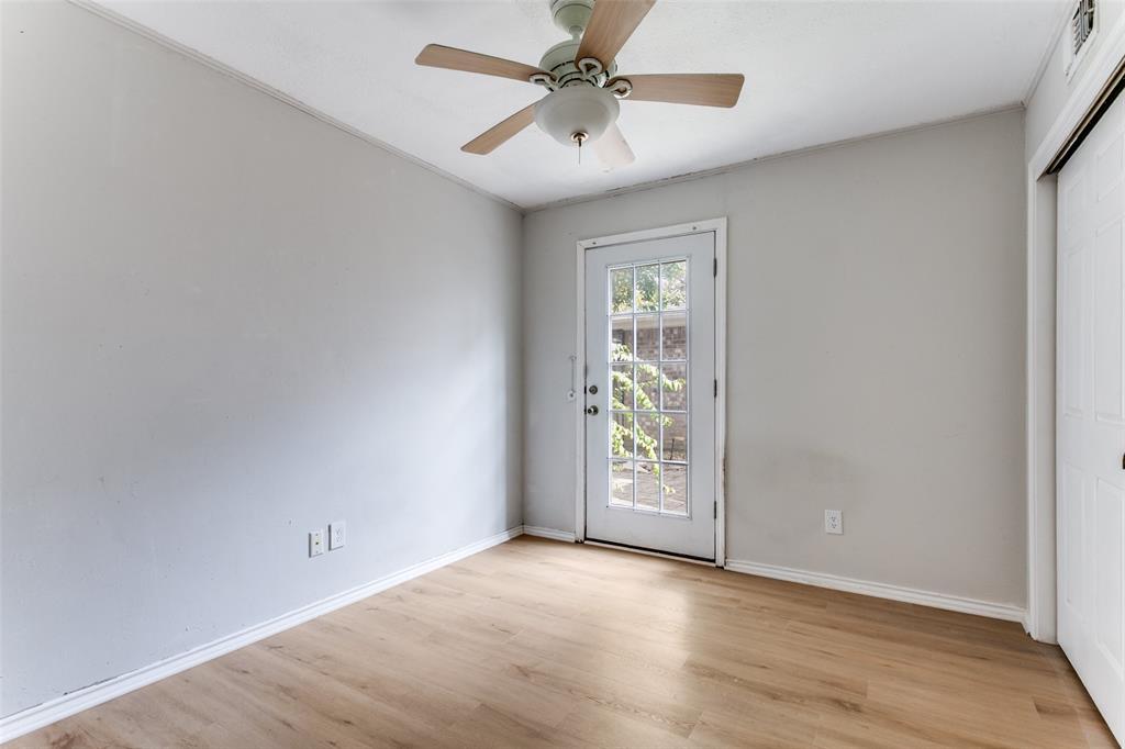 9416 Penny Lane Irving, TX 75063 - Photo 14 of 21 an empty room with windows and fan