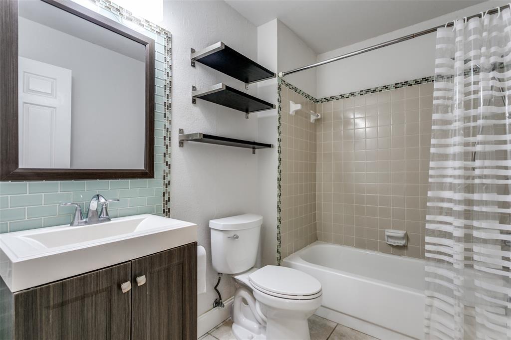 9416 Penny Lane Irving, TX 75063 - Photo 15 of 21 a bathroom with a sink toilet and shower