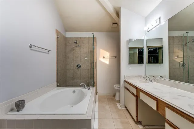 a bathroom with a tub sink and mirror
