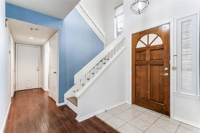 a view of an entryway with wooden floor