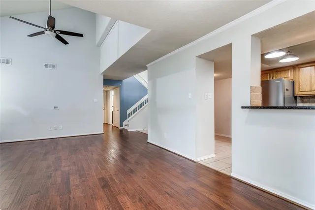 a view of empty room with wooden floor