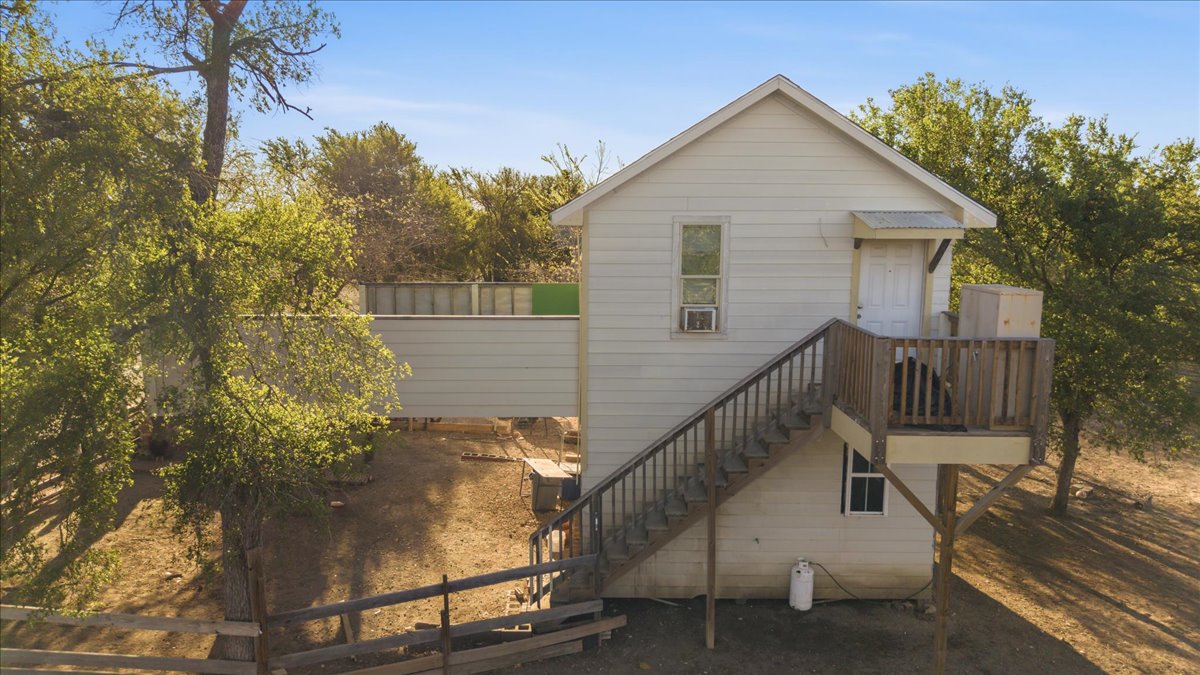 17309 Skog Road Elgin, TX 78621 - Photo 13 of 17 Rear view of property with stairway and a wooden deck