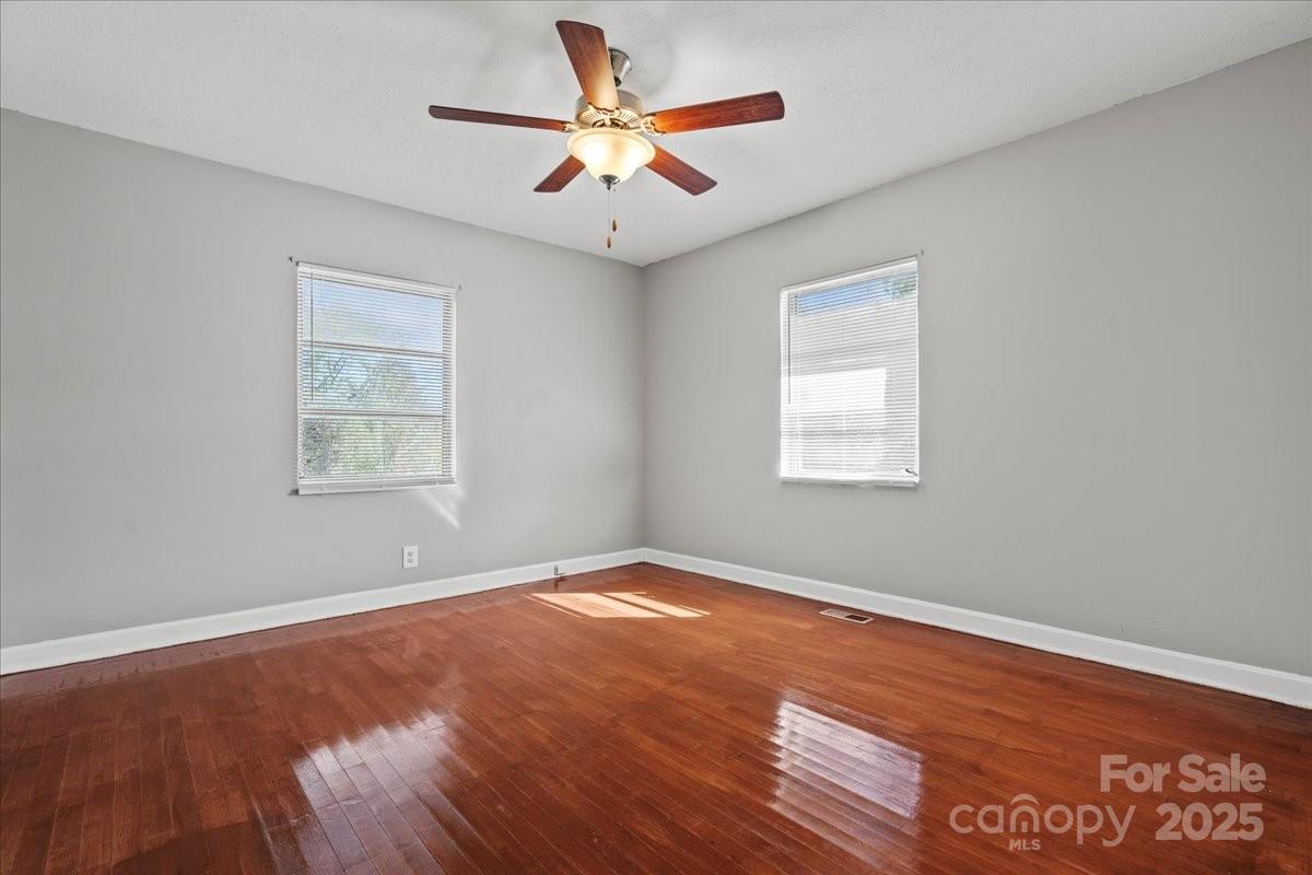 5155 Percy Lane Wallace, SC 29596 - Photo 12 of 33 an empty room with wooden floor and windows