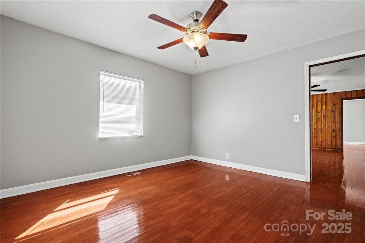 5155 Percy Lane Wallace, SC 29596 - Photo 14 of 33 an empty room with wooden floor and a ceiling fan