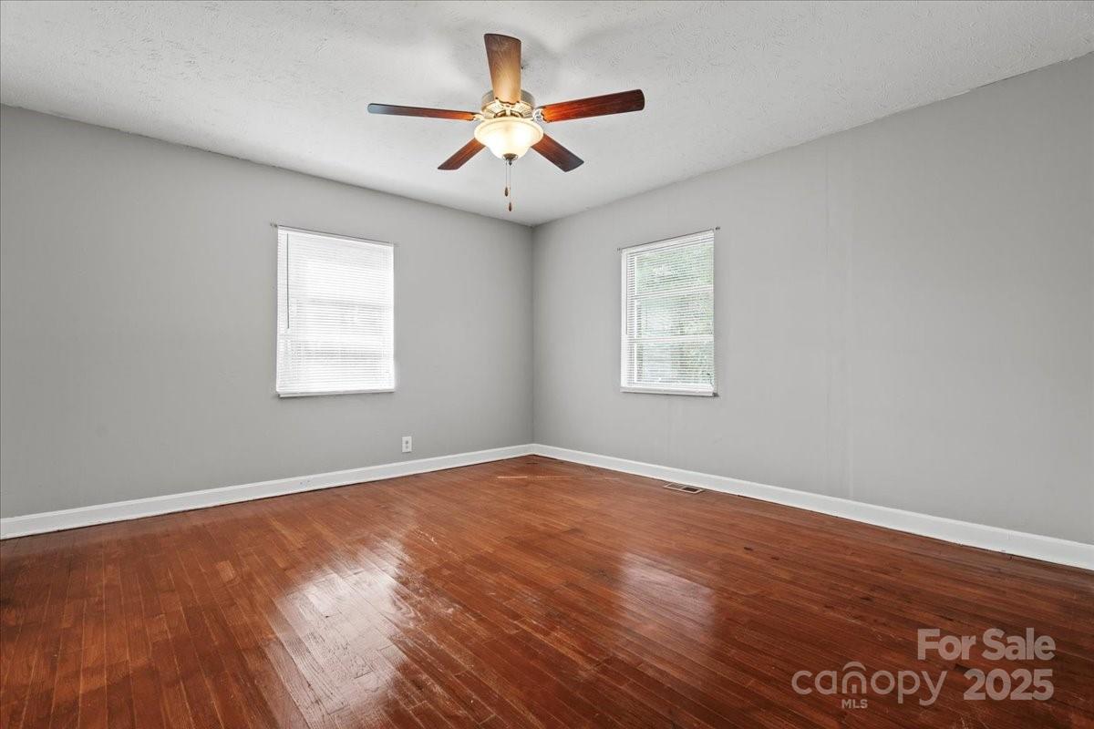5155 Percy Lane Wallace, SC 29596 - Photo 19 of 33 an empty room with wooden floor and windows
