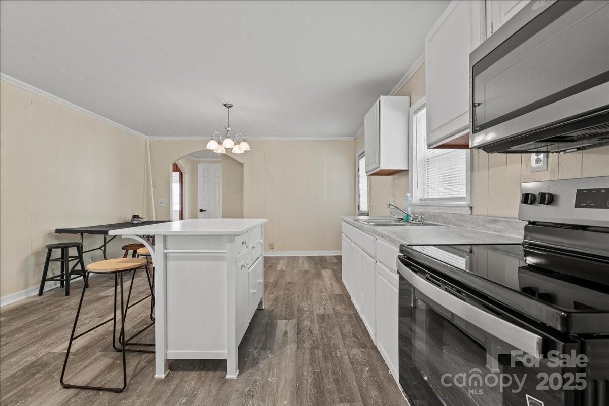 5155 Percy Lane Wallace, SC 29596 - Photo 23 of 33 a kitchen with stainless steel appliances granite countertop a stove and cabinets