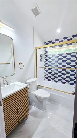 a bathroom with a sink a toilet and mirror
