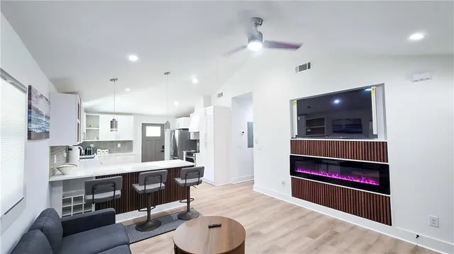 a living room with stainless steel appliances kitchen island granite countertop furniture and a view of kitchen
