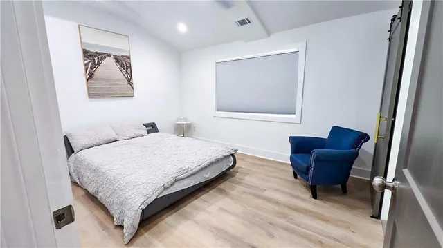 a bedroom with a bed and a chair