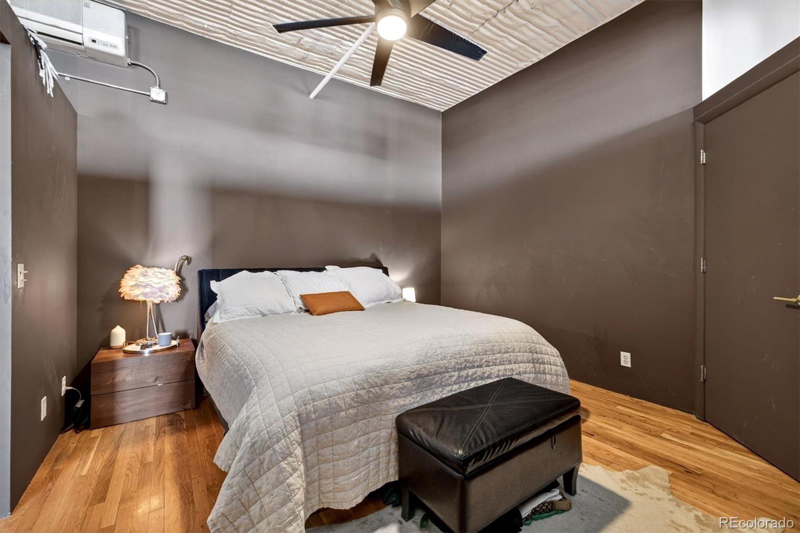 2261 Blake Street, Unit 4F Denver, CO 80205 - Photo 19 of 38 a bedroom with a bed and window