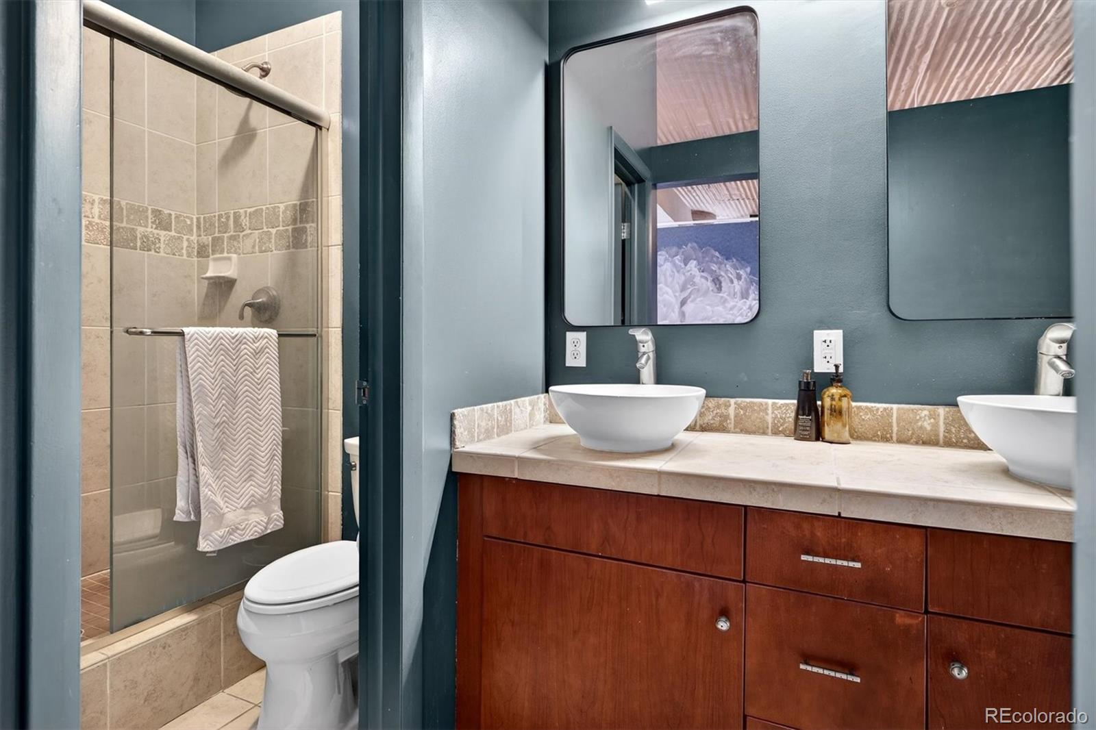 2261 Blake Street, Unit 4F Denver, CO 80205 - Photo 23 of 38 a bathroom with a sink a toilet and shower