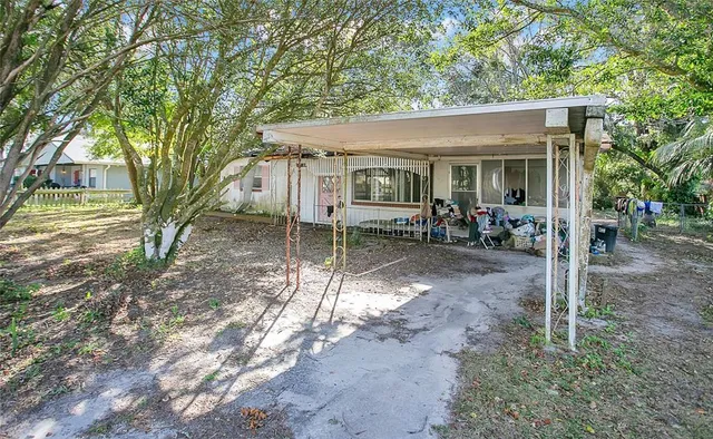 a view of a house with yard and sitting area
