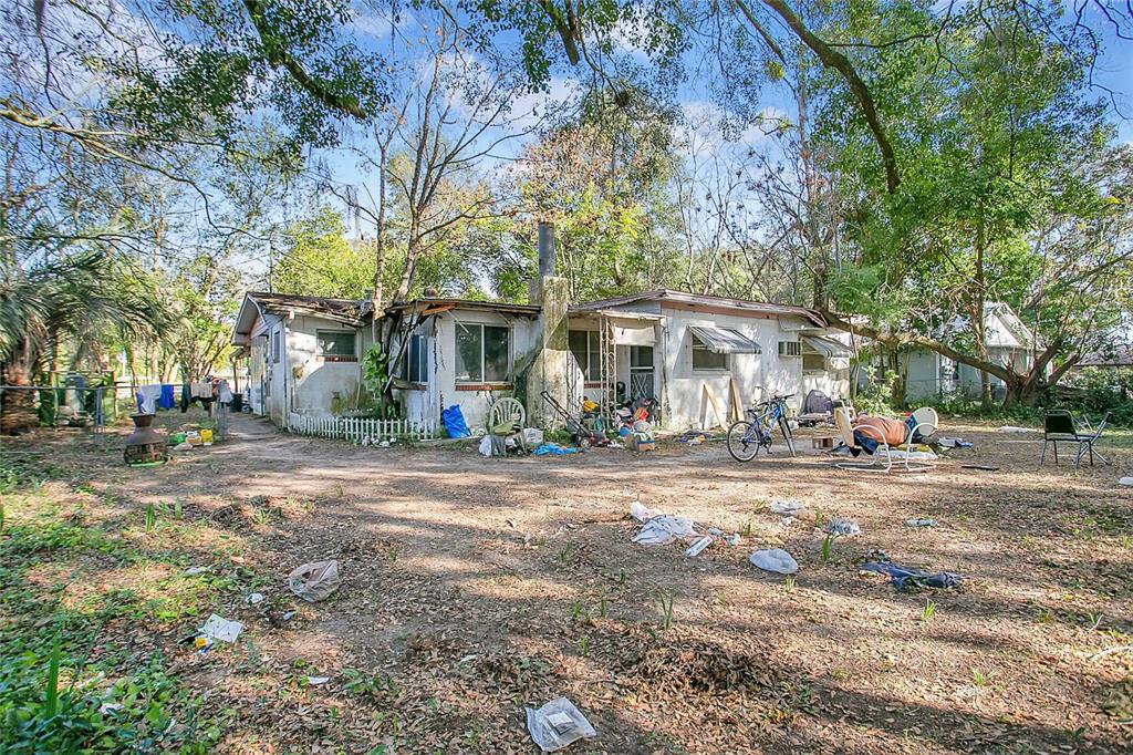 1506 Northeast 57th Street Ocala, FL 34479 - Photo 5 of 6 a view of a house with a yard and large trees