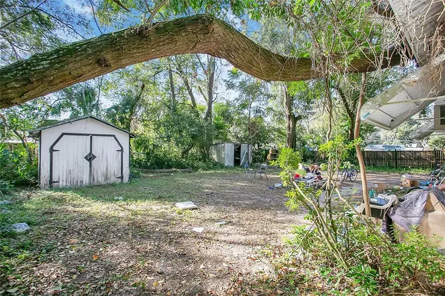 a view of a wooden house with a yard