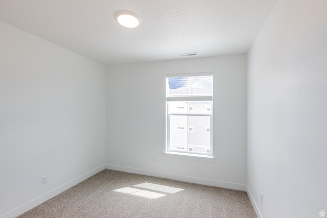 693 West 4500th South, Unit O304 Mapleton, UT 84664 - Photo 5 of 16 Spare room featuring baseboards and light carpet