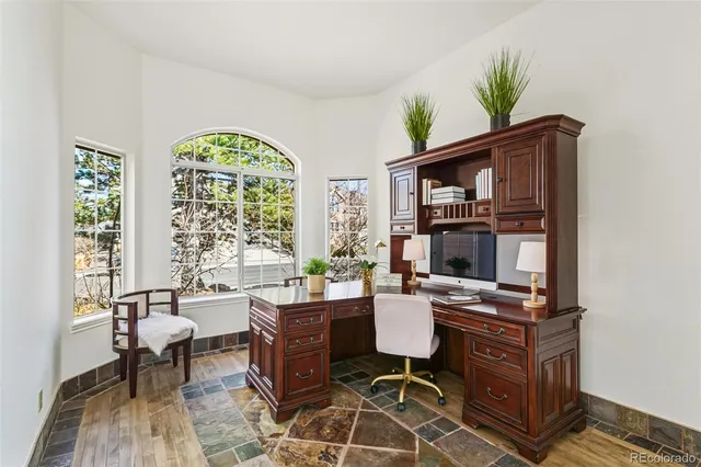 a workspace with furniture bookshelf and a window