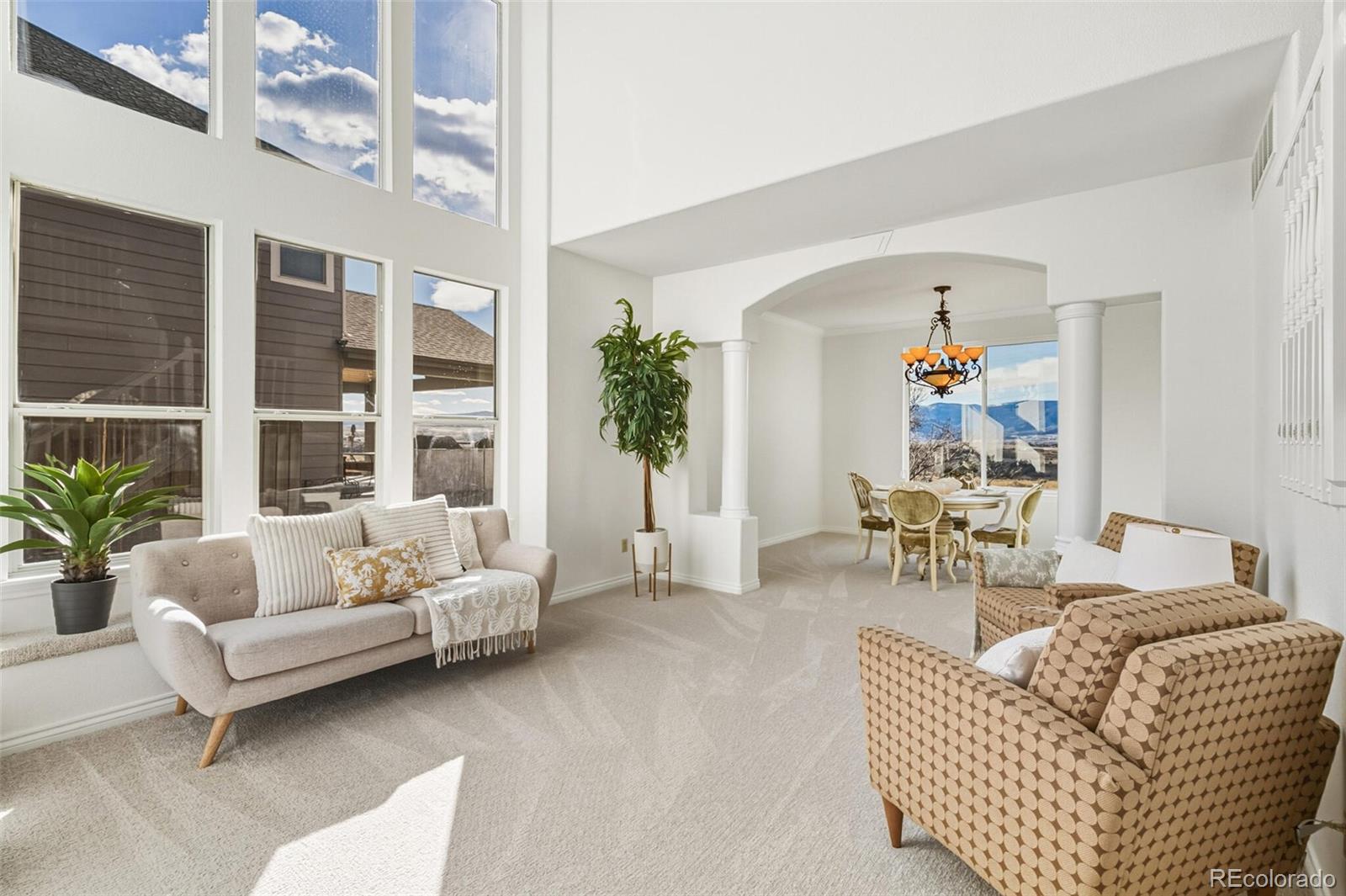 10275 Baneberry Place Highlands Ranch, CO 80129 - Photo 17 of 50 a living room with furniture and a large window