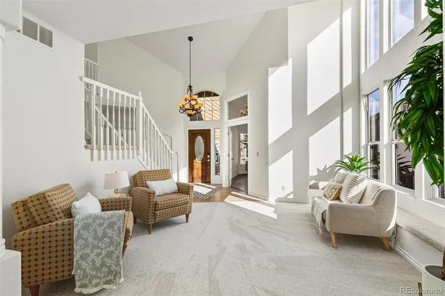 a living room with furniture and a chandelier