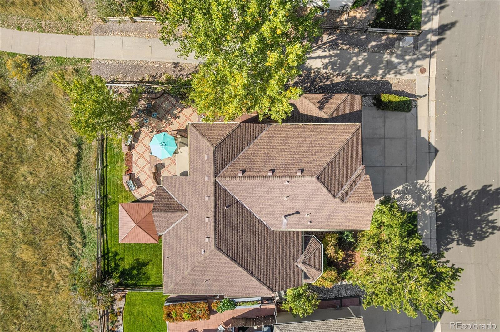 10275 Baneberry Place Highlands Ranch, CO 80129 - Photo 3 of 50 an aerial view of a house with a yard swimming pool and outdoor seating