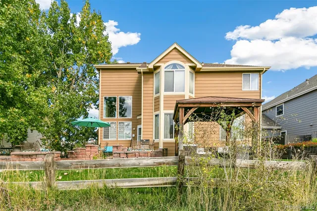 a front view of a house with swimming pool having outdoor seating