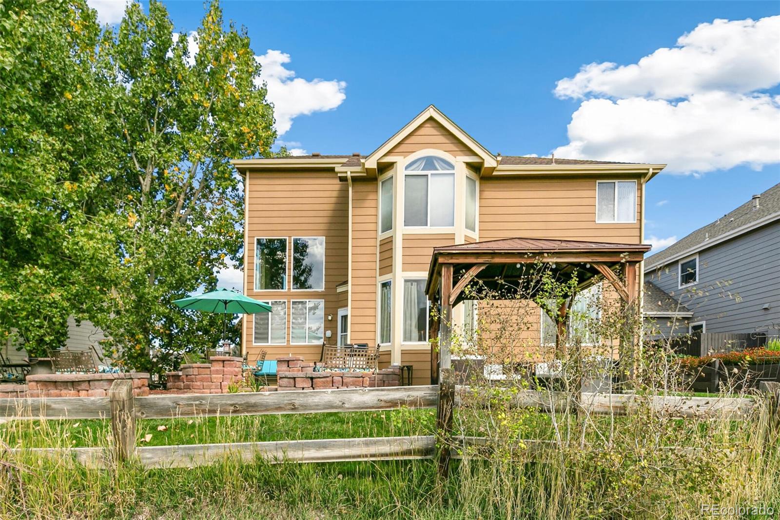 10275 Baneberry Place Highlands Ranch, CO 80129 - Photo 37 of 50 a front view of a house with swimming pool having outdoor seating