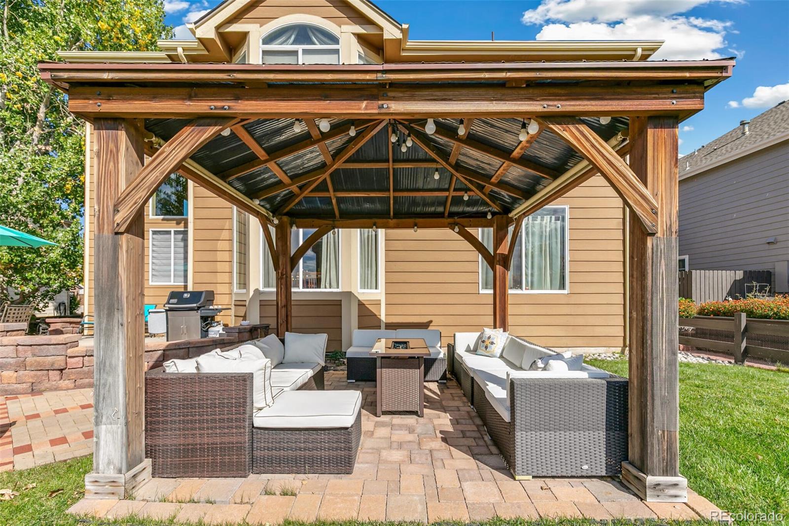 10275 Baneberry Place Highlands Ranch, CO 80129 - Photo 40 of 50 a view of a patio with couches chairs and wooden floor
