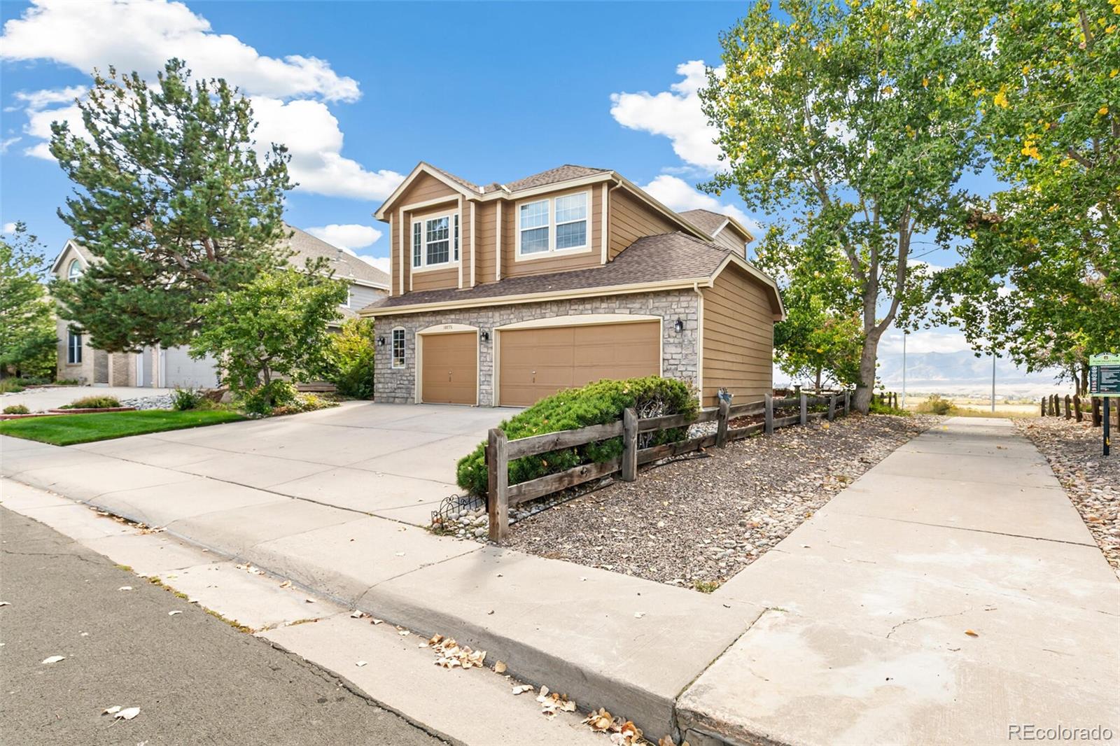 10275 Baneberry Place Highlands Ranch, CO 80129 - Photo 4 of 50 a front view of a house with a yard and garage
