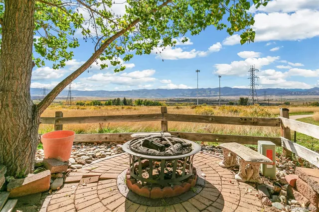 a view of a swimming pool with a patio and a yard