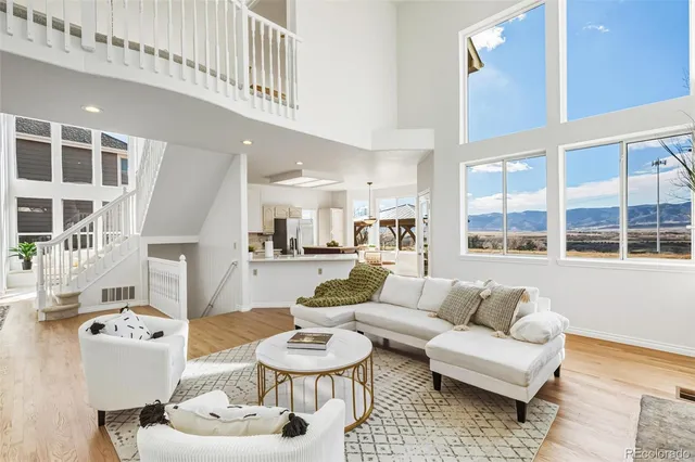 a living room with furniture and a dining table with kitchen view