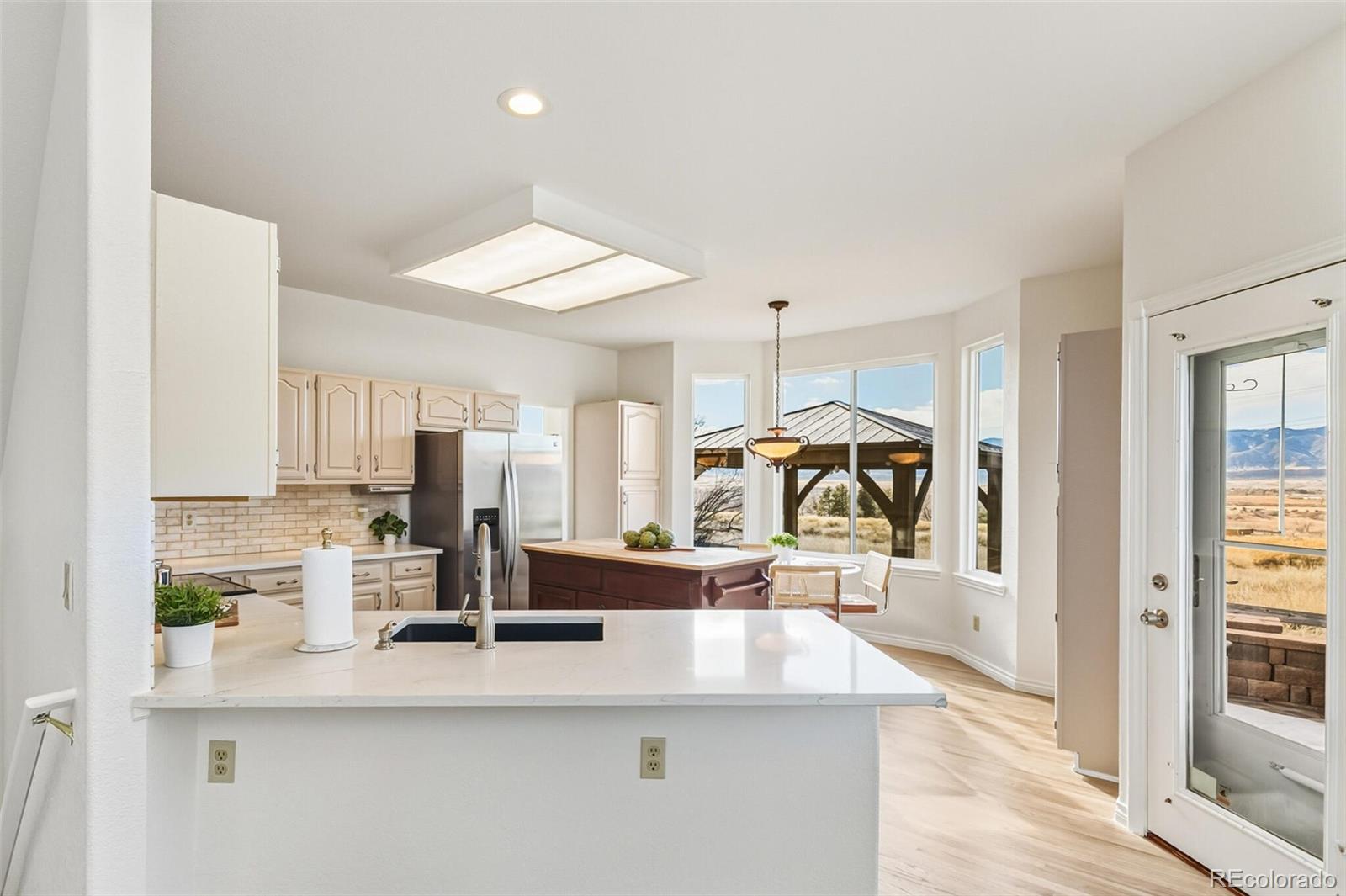 10275 Baneberry Place Highlands Ranch, CO 80129 - Photo 9 of 50 a kitchen with stainless steel appliances kitchen island granite countertop a sink and cabinets