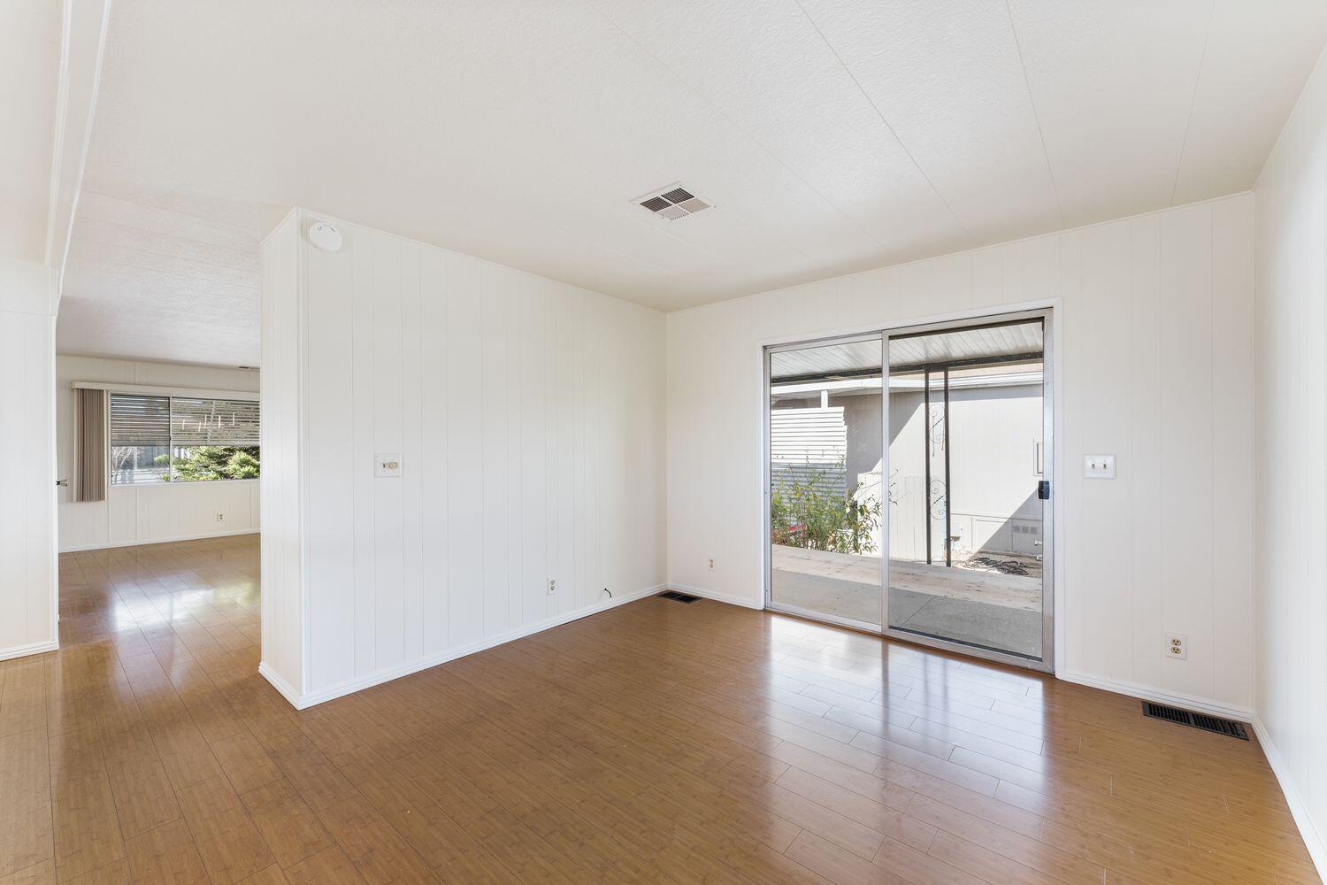 6180 Via Real, Unit 118 Carpinteria, CA 93013 - Photo 15 of 37 a view of an empty room with wooden floor and a window