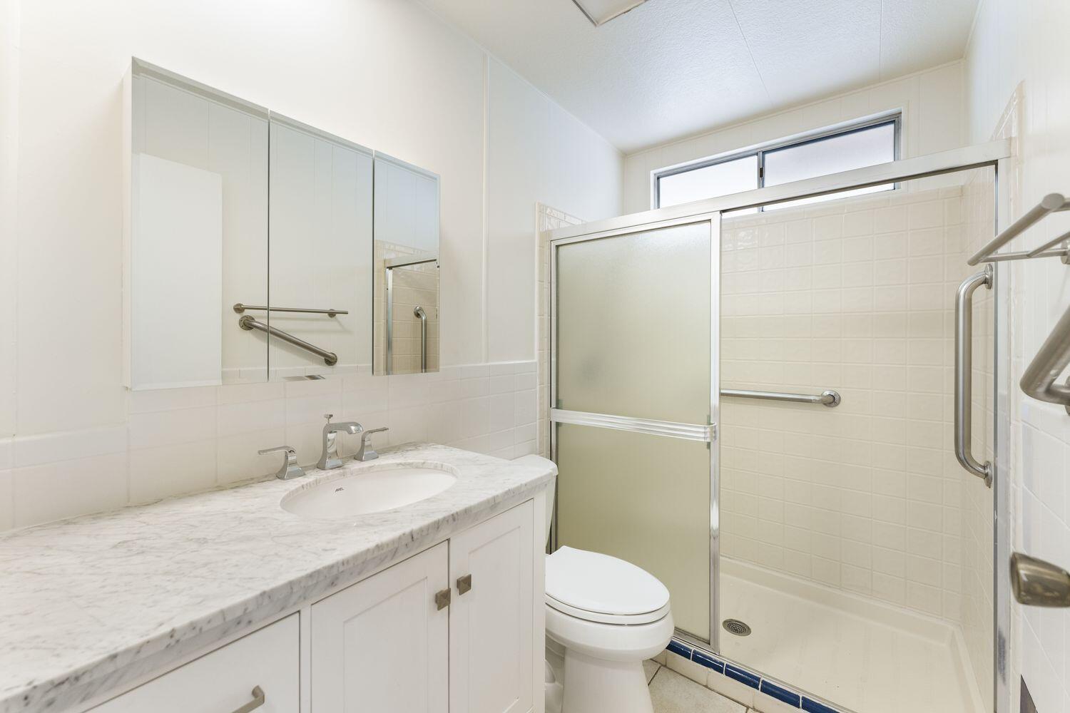 6180 Via Real, Unit 118 Carpinteria, CA 93013 - Photo 25 of 37 a bathroom with a granite countertop sink toilet and shower