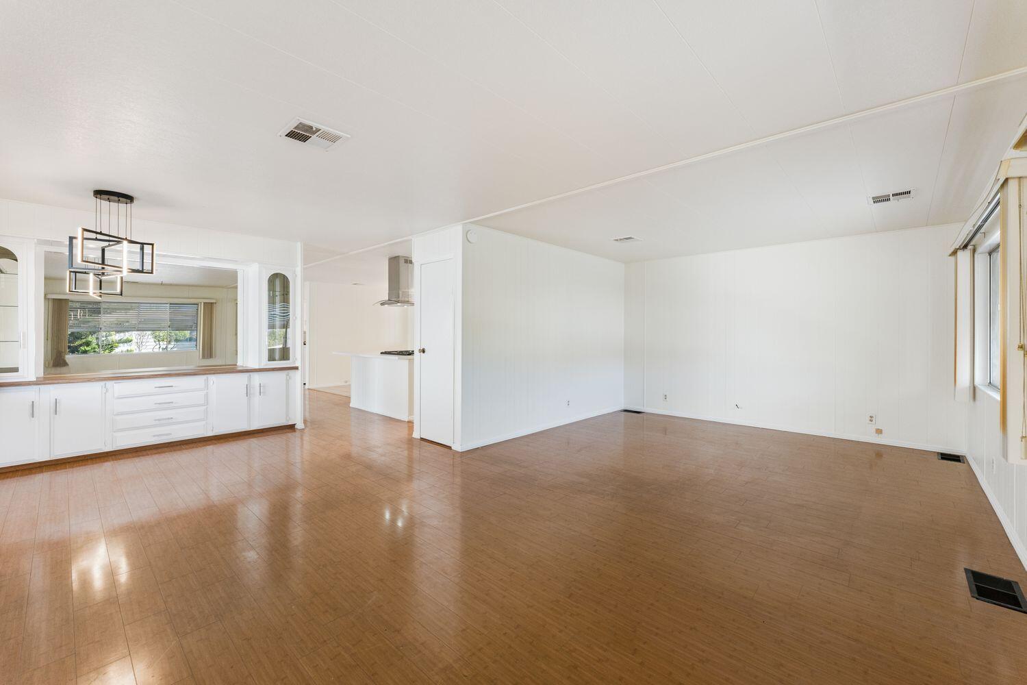 6180 Via Real, Unit 118 Carpinteria, CA 93013 - Photo 6 of 37 a view of an empty room with a window and wooden floor
