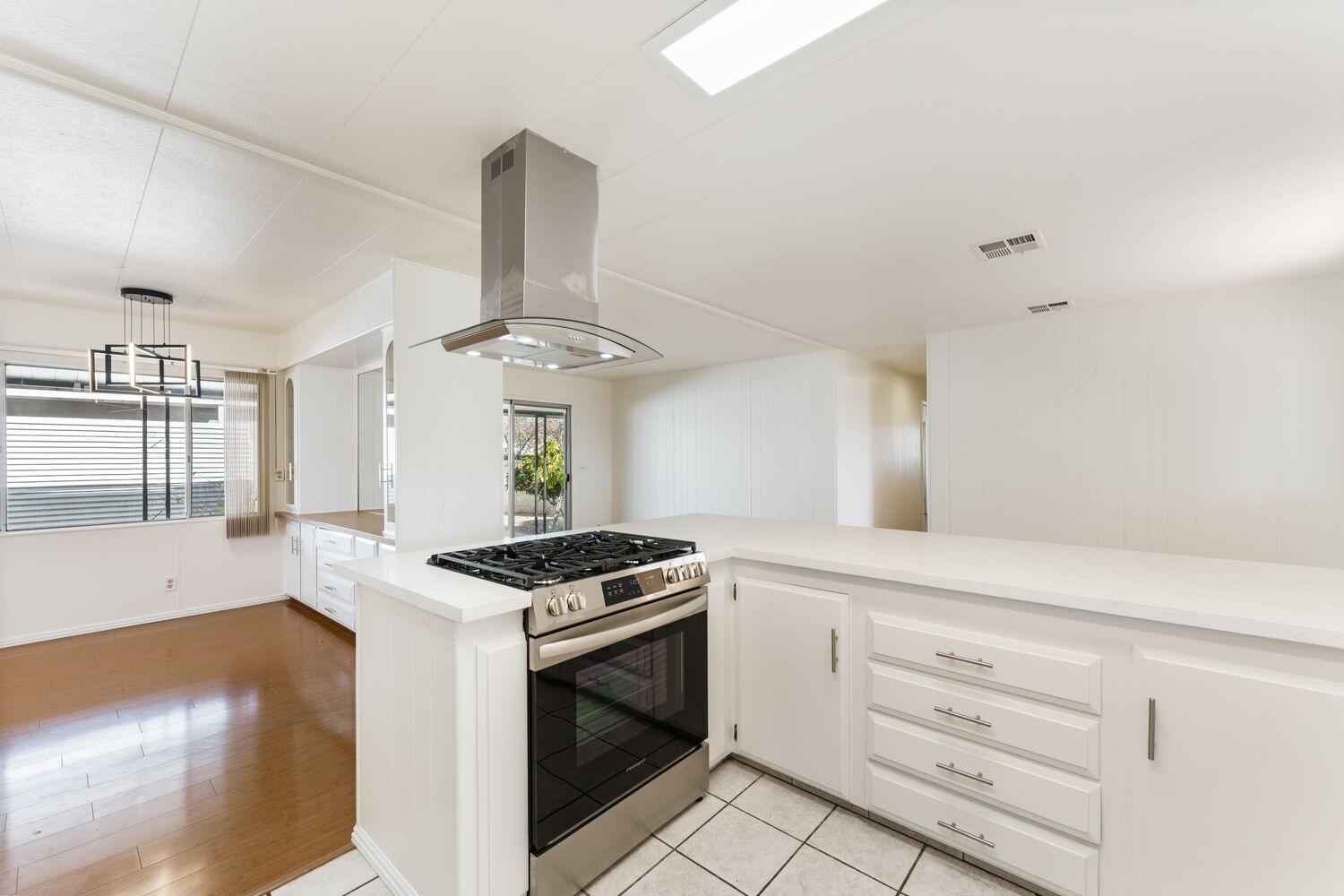 6180 Via Real, Unit 118 Carpinteria, CA 93013 - Photo 9 of 37 a kitchen with stainless steel appliances a stove a sink and a refrigerator