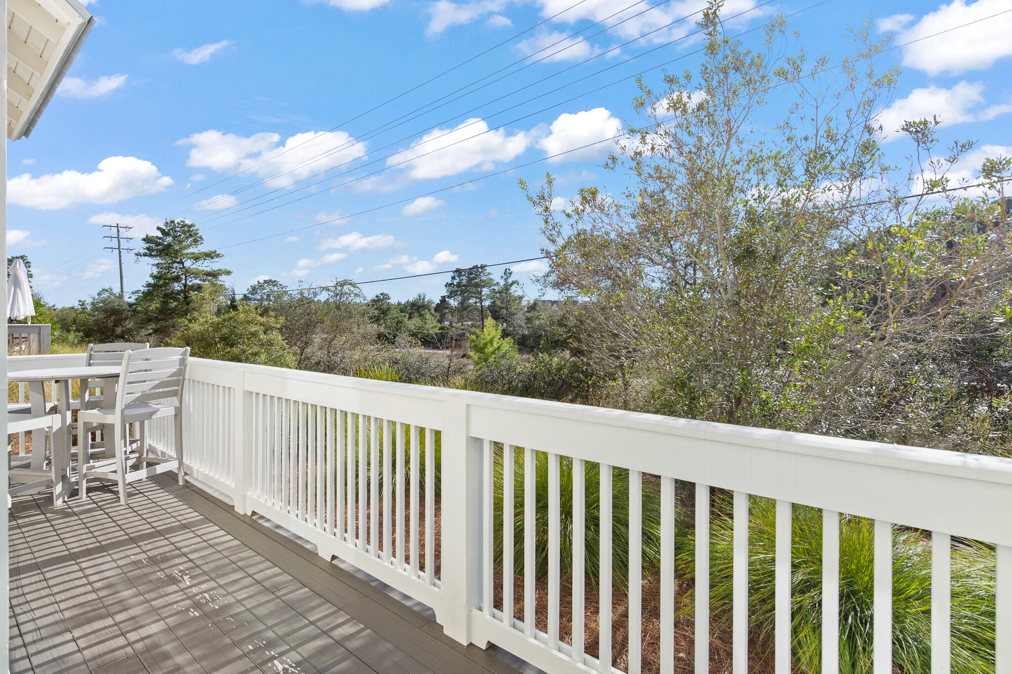 103 Milestone Dr Inlet Beach, Unit A Inlet Beach, FL 32461 - Photo 18 of 49 a balcony with wooden floor and fence