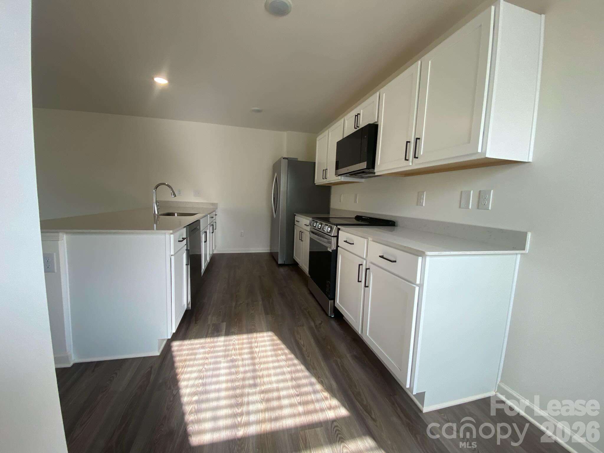 611 Richard Road Lexington, NC 27292 - Photo 2 of 10 a kitchen with stainless steel appliances granite countertop a sink stove and white cabinets