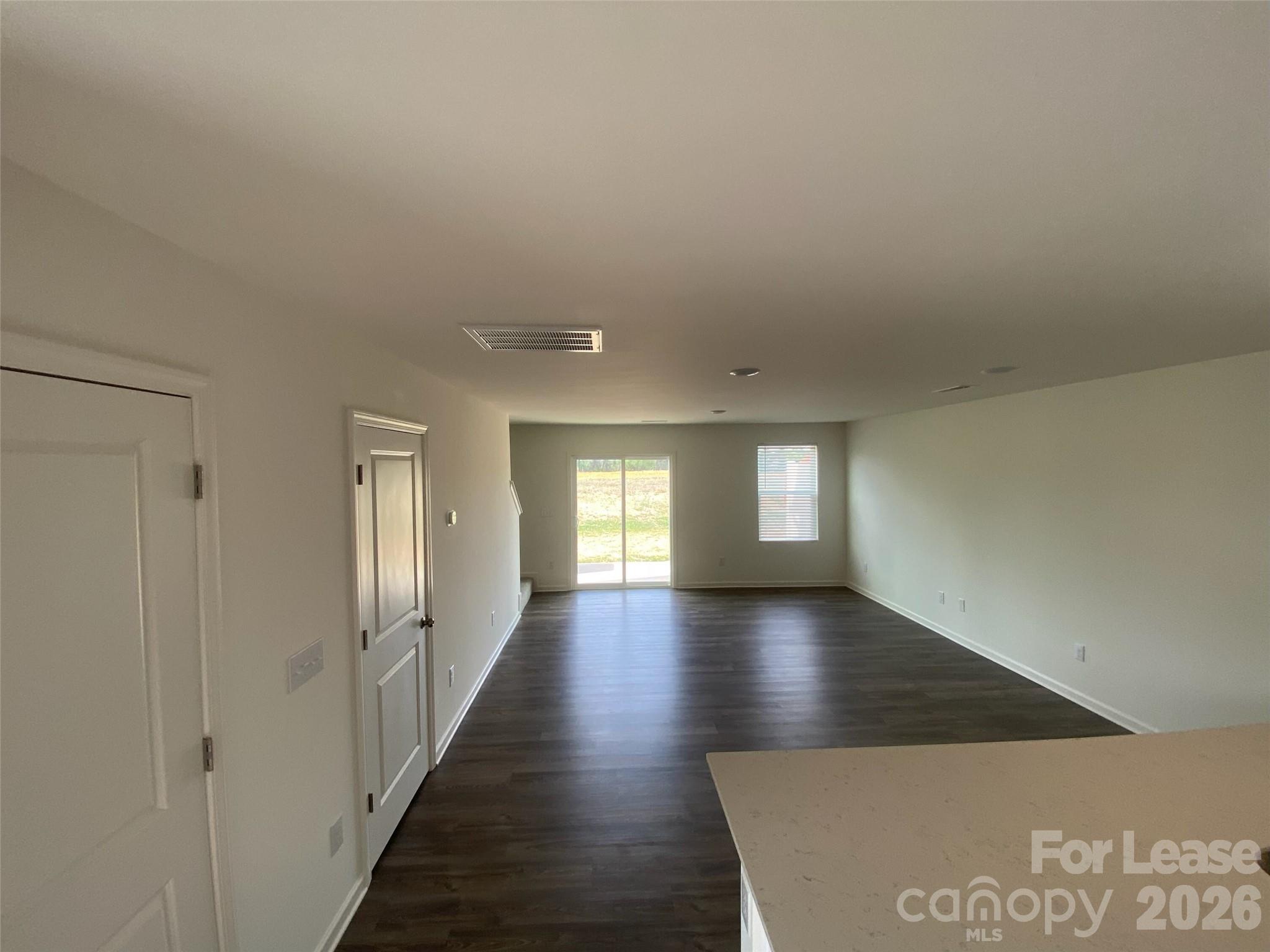 611 Richard Road Lexington, NC 27292 - Photo 4 of 10 a view of an empty room with wooden floor and a window